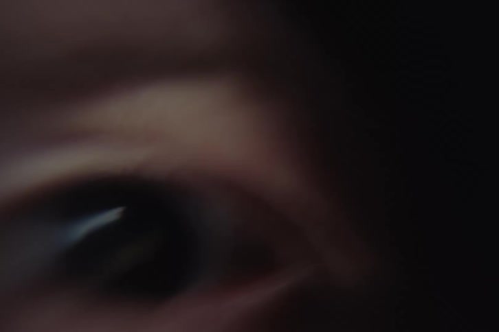 Detail of a human eye reveals subtle reflections and delicate red lines