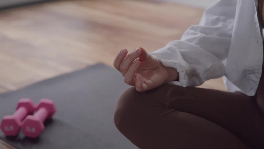 The woman meditates on a yoga mat