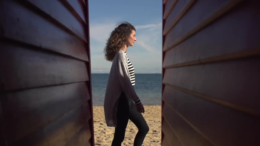 Woman walks down the beach