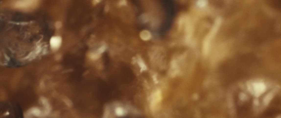 Golden bubbles rise in a hot liquid with an effervescent appearance