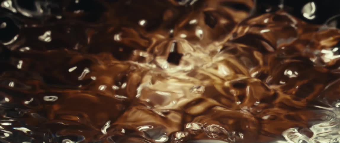 Hot golden liquid bubbles in intense and shimmering motion