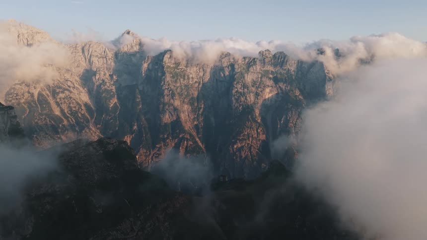 Rocky peaks shrouded in clouds reveal the grandeur of the mountain
