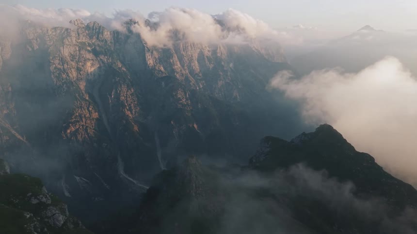 The clouds touch the peaks of the mountains