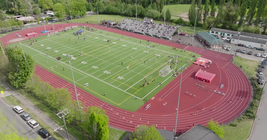 Athletes compete in a variety of track and field sports at a springtime meet