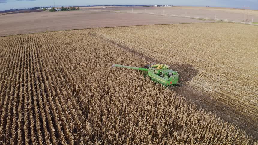 The farm vehicle is collecting the crops on the farm