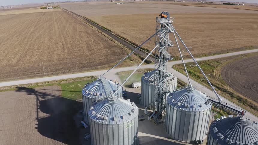 The truck pulls up to the silos on the farm