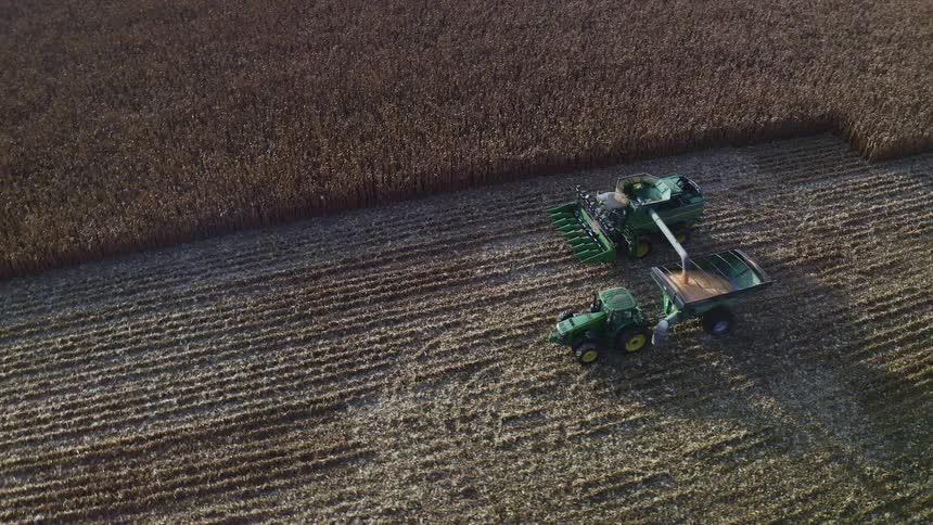 The tractor is harvesting the crops