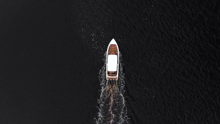 Aerial of a boat moving on a body of water outdoors during daytime