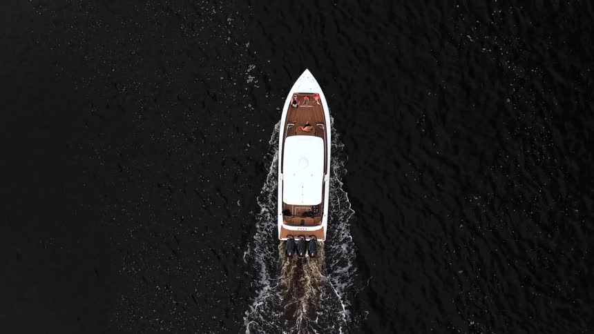 Aerial of a boat as it travels across the surface of the ocean
