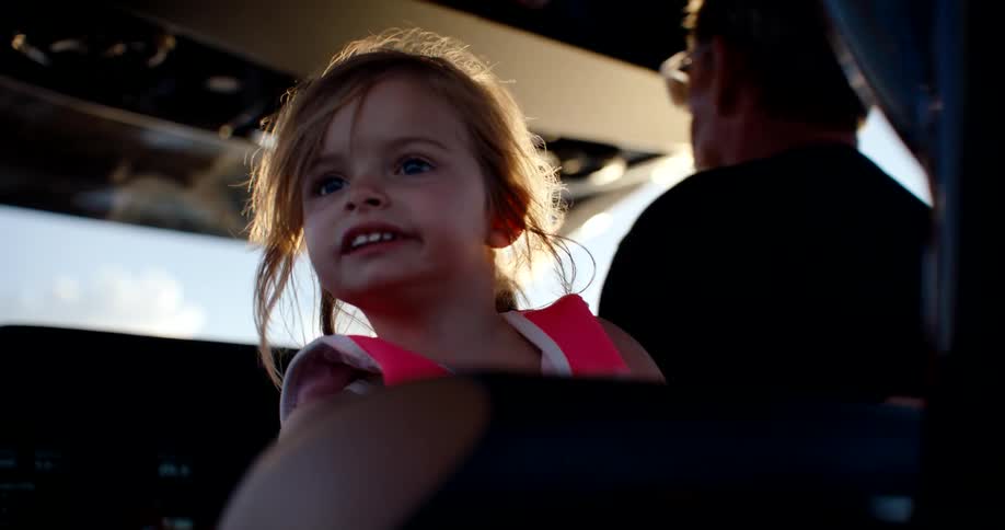 The girl is happy while riding on the boat