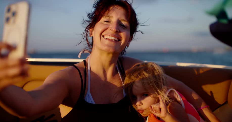 Mother and son sitting together on a boat during daytime