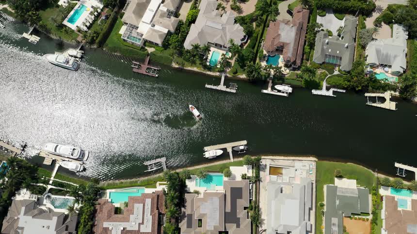 Aerial of resort buildings connected by a canal with boats during daytime