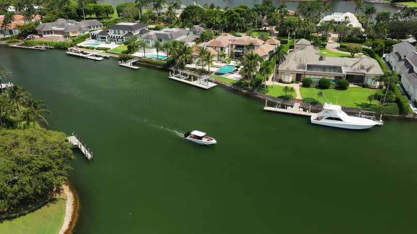Waterfront residential area with yachts pools and tropical greenery