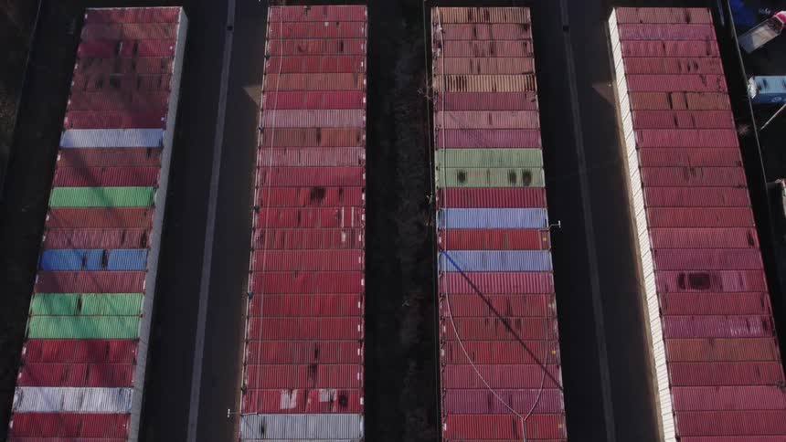 Aligned containers form colorful rows seen from above