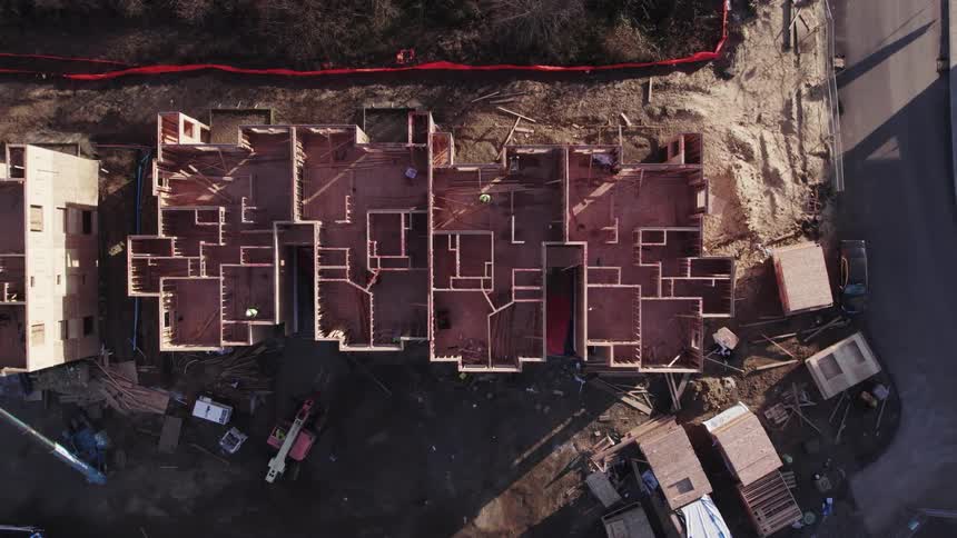 Aerial view of building under construction with machinery below