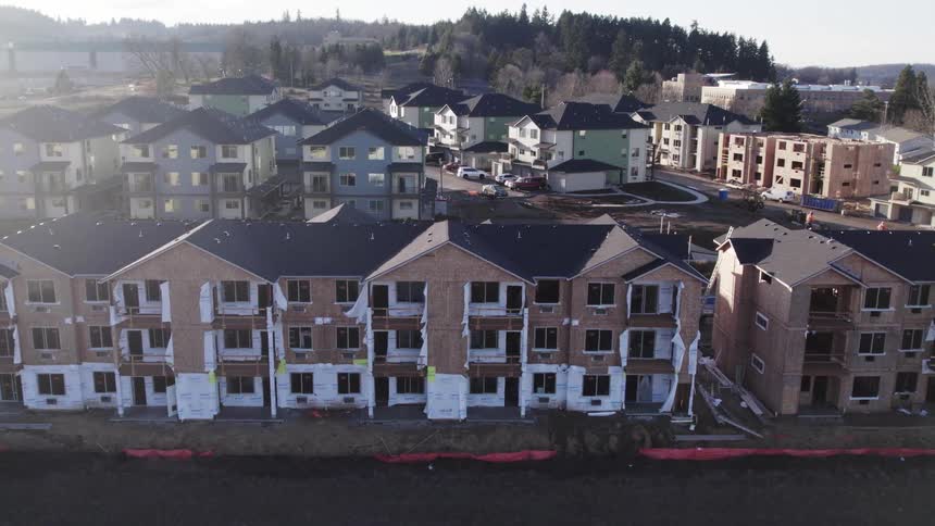 A residential area in the city at midday with multiple apartment buildings clustered together