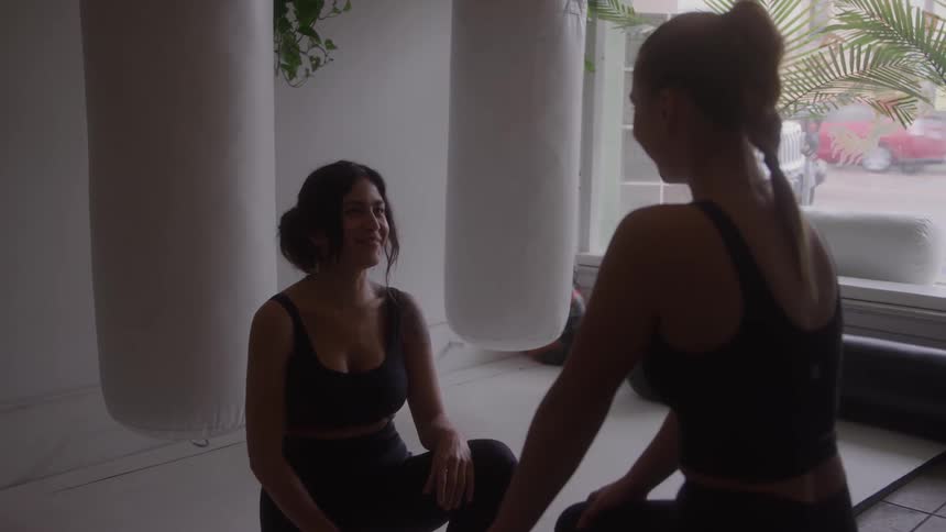 Two women in sportswear talking during a workout