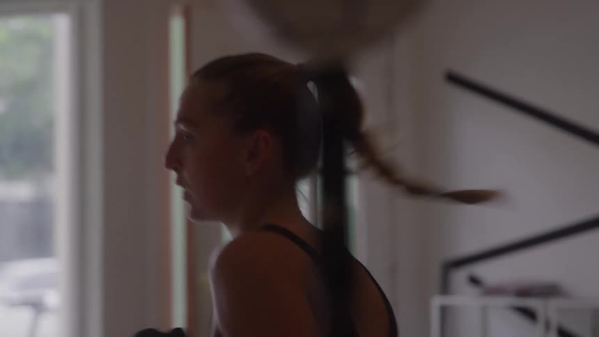 Woman training boxing with gloves in an indoor space