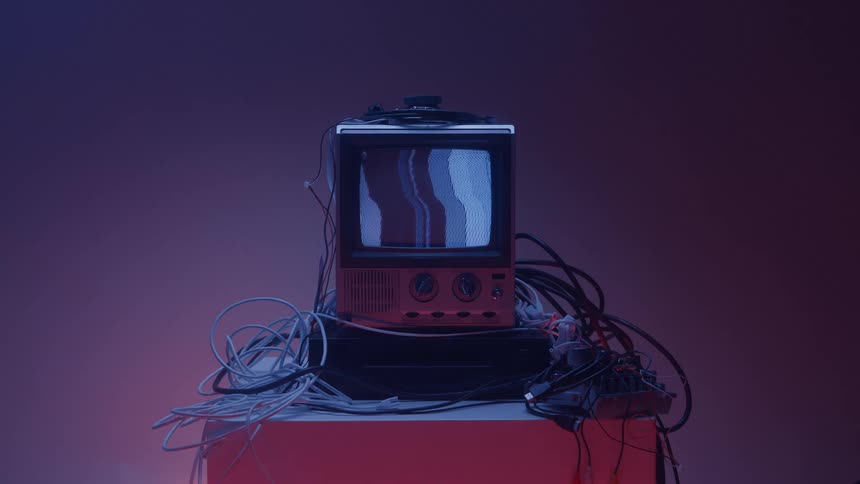 Close up of an electronic display device arranged with wires on a table in a room