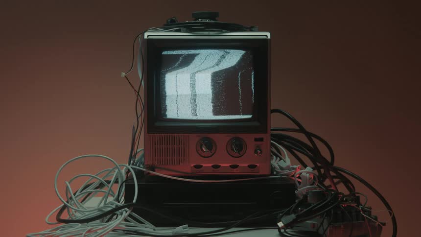 Close up of a connected electronic display device on a table in a red lit room