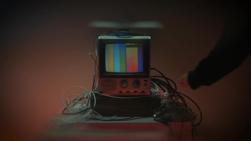 Person turning on an old television