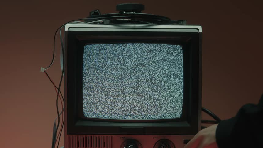 Hand turning off a television with no signal