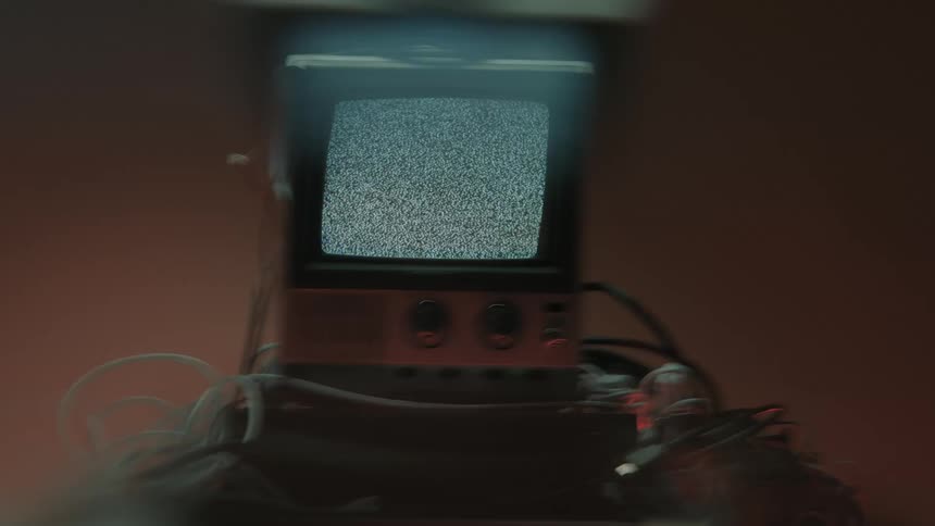 Old television turned on displays static noise on the screen