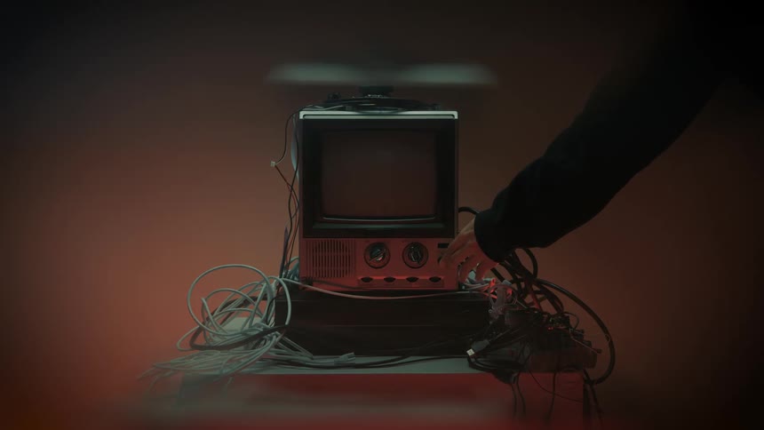 The person flips the knob on the telvision