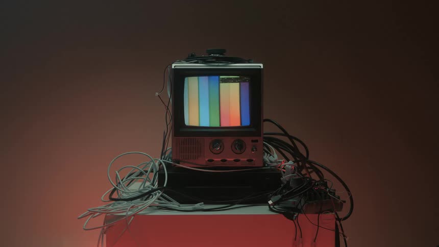 Old television displaying a color screen with different colors