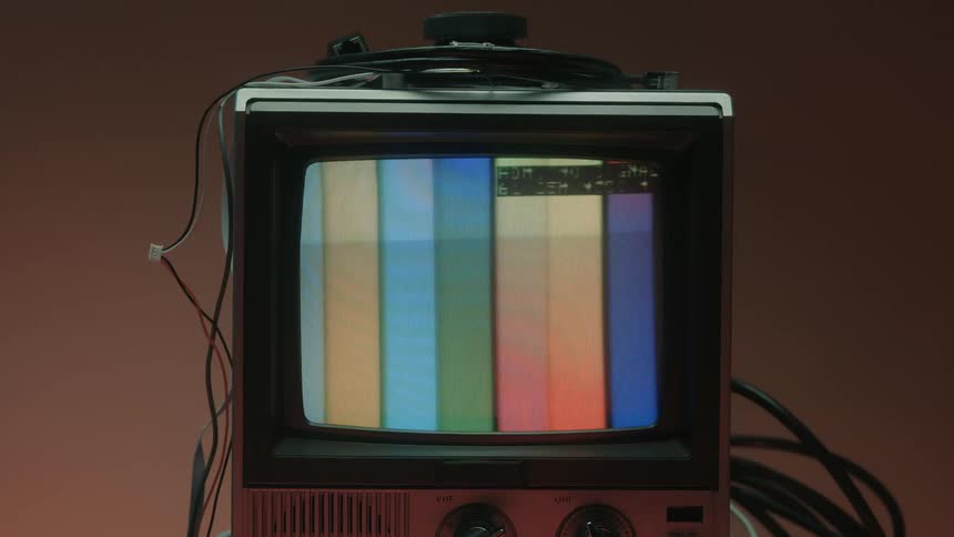 Old television turned on displays vertical color bars on the screen