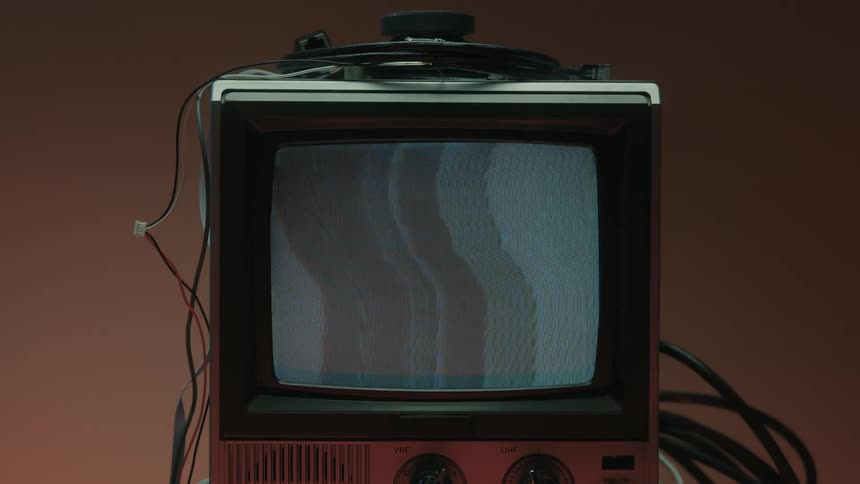 Close up of a person turning on a connected electronic display device to show a static screen