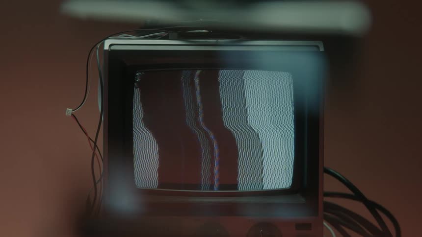 Old television with no signal against a neutral background