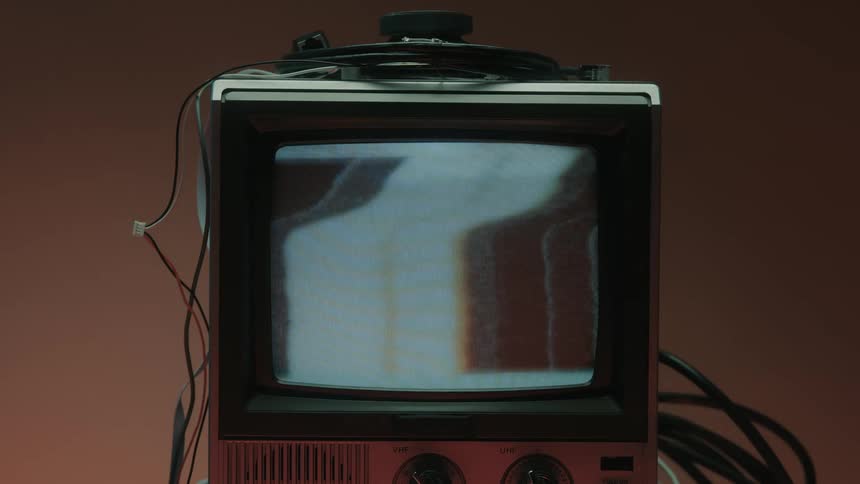 Close up of a person turning on a connected electronic display device to show a static screen