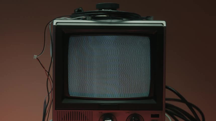 Close up of a person turning on a connected electronic display device on a table to show a static screen