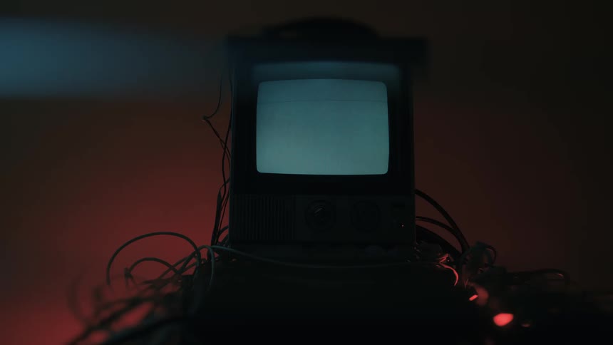 Old television displays icons in a dark environment