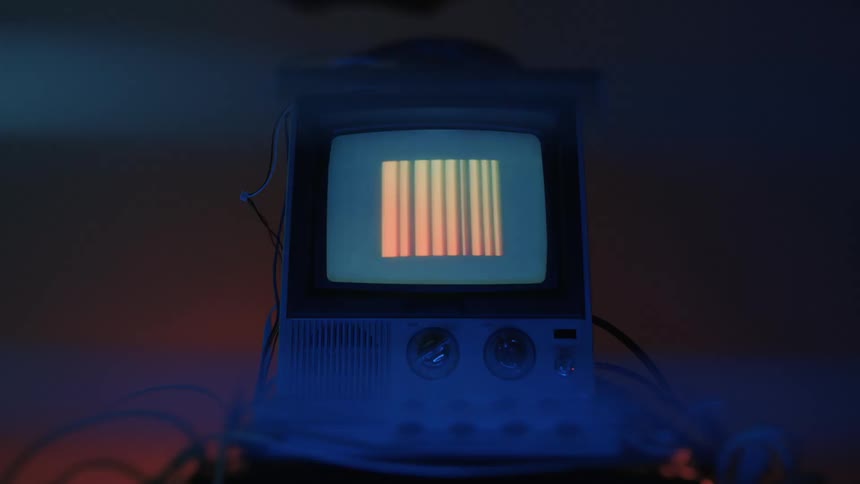 Many different symbols flash on the television in the dark room