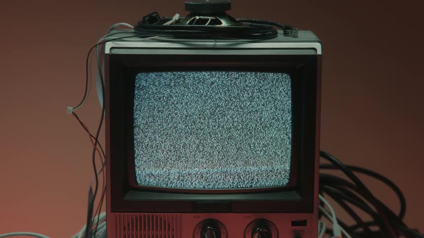 A speaker is on top of the old television