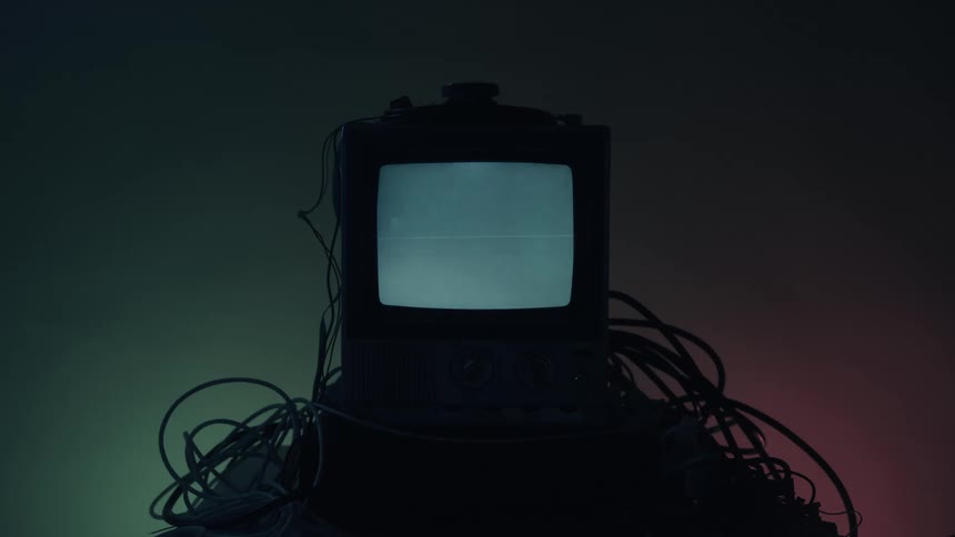 Vintage monitor displays horizontal bar with scattered cables over gradient background