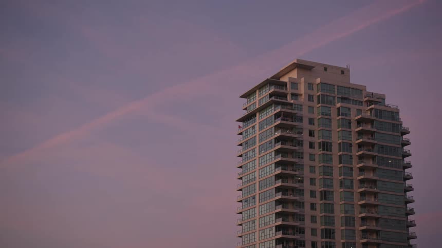 Modern building standing out against a pinkish sky at sunset