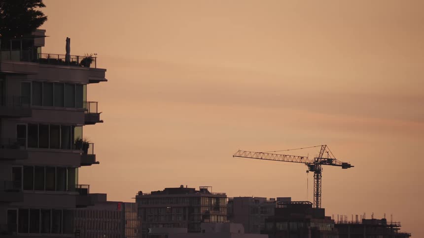City at sunset with a crane in the background