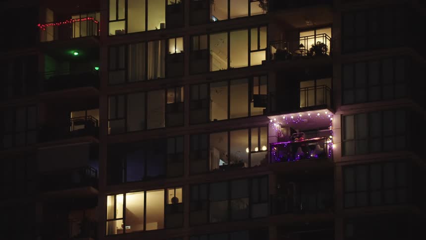 The lights flash on the balcony of the apartment building