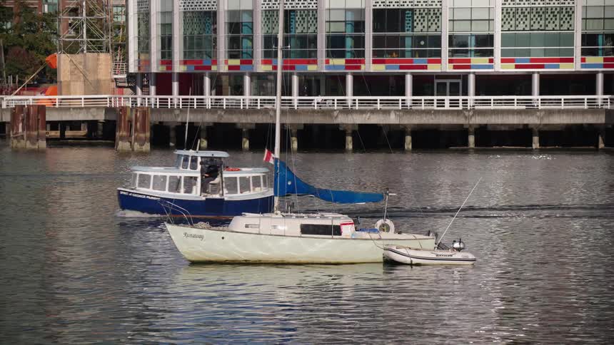 The ferry passes the large building