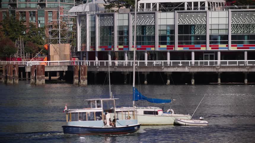 The small ferry travels past the city