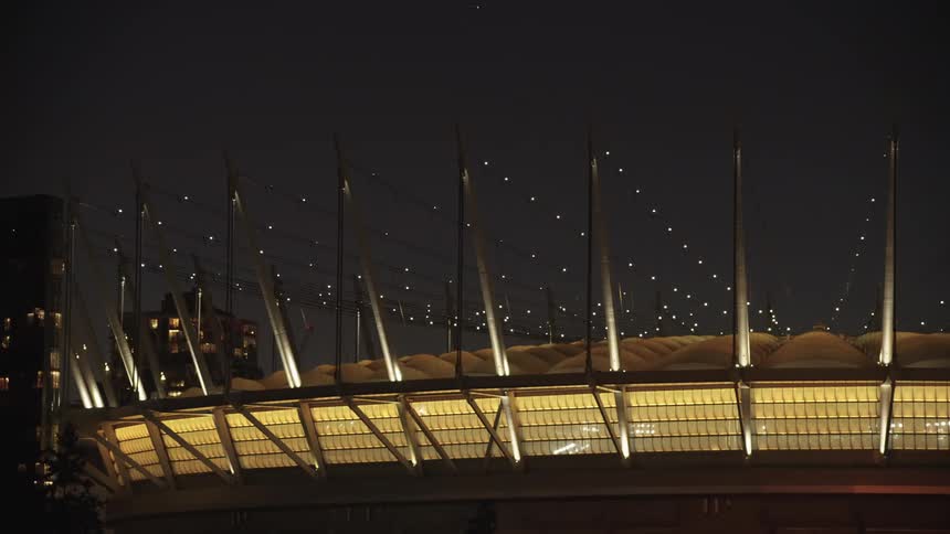 The stadium has flashing lights on the roof