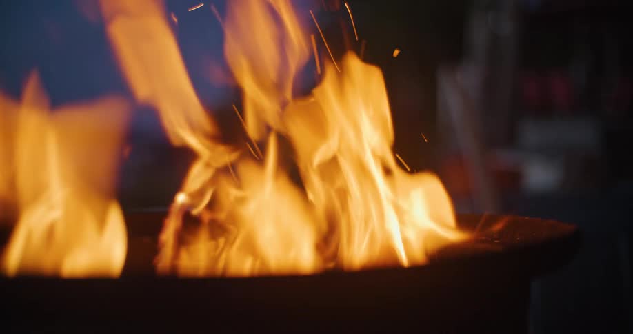 Marshmallow being roasted over a fire in an outdoor setting