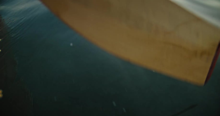 Paddle glides gently across the waters surface creating small whirlpools