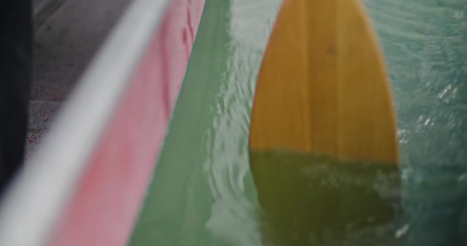 Close up of yellow oar paddling on a lake