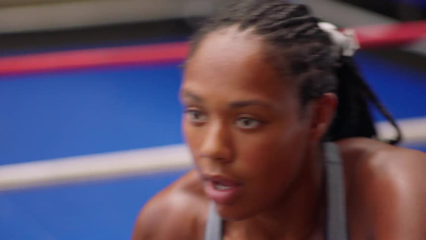 The woman is working out in the gym