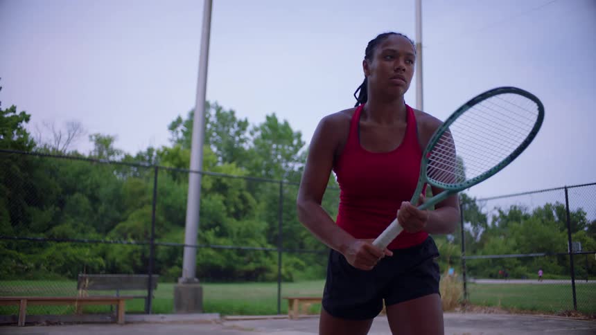 The woman swings her tennis racket
