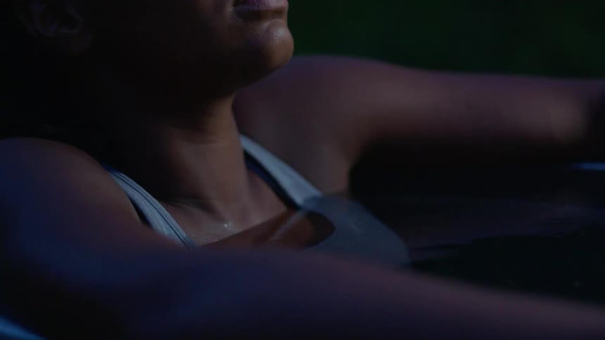 Woman relaxing in the water at night